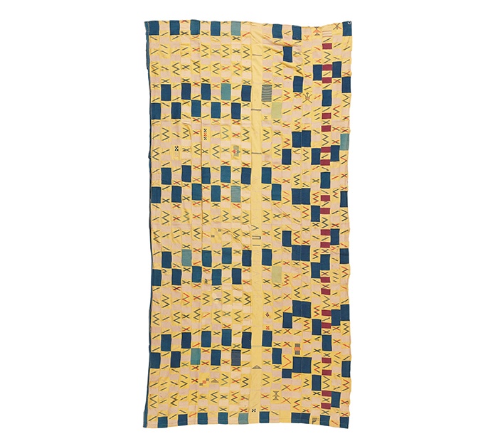 LOT 180 | EARLY EWE CLOTH | TOGO / EASTERN GHANA strip woven cotton, formed of twenty strips, navy blocks on an cool yellow ground, the central strip unadorned and signed, the design becoming irregular on the opposing side, weft float motifs throughout 304cm x 155cm | £300 - £500 + fees Provenance: The Keir McGuinness Collection of African Textiles